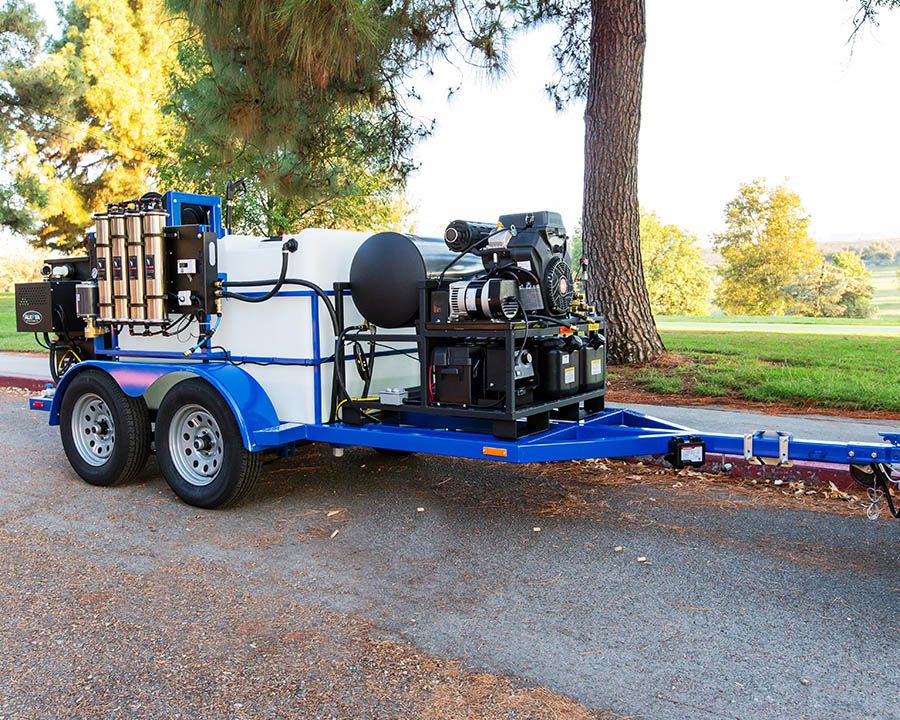 A blue tandem with a filter bank at the back, a white tank and an engine-driven hot water machine toward the tongue