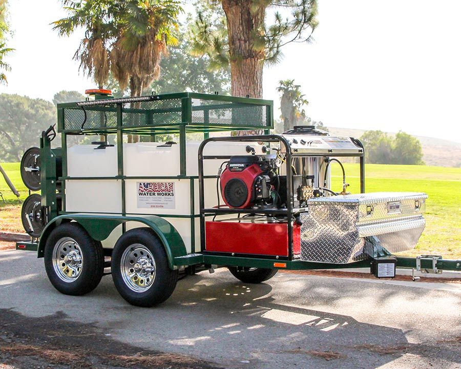 A green tandem with a caged top, two tanks, a hot water machine and a diamond-plate toolbox