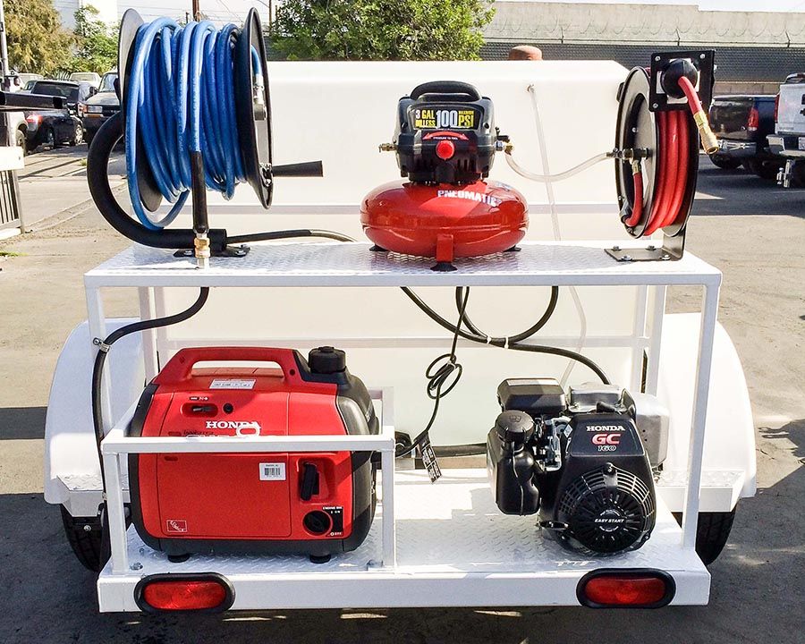 Rear of a compact white cart with a Honda generator, a gas-engine washer, an air compressor and two hose reels