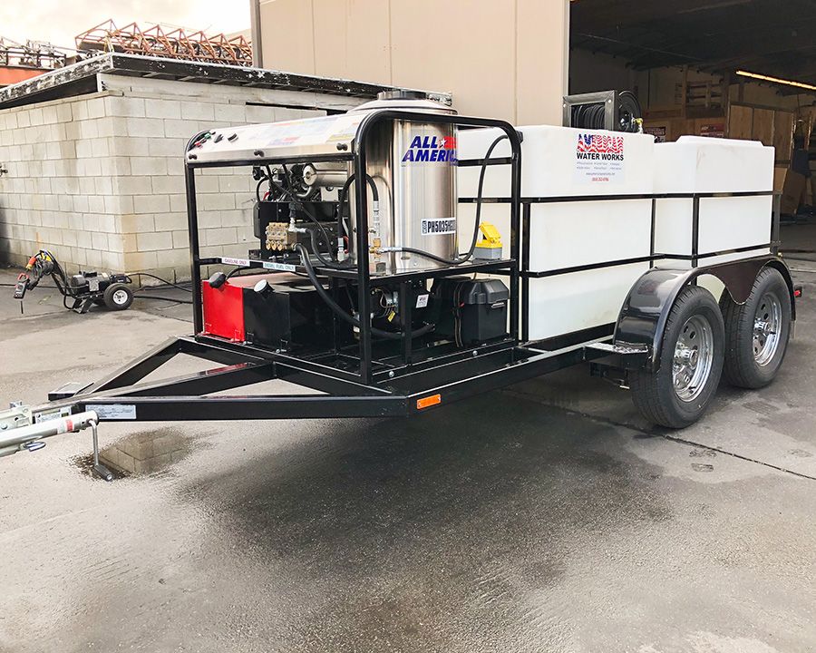 An All American hot water skid on a tandem trailer, the AWW flag decal on its tank